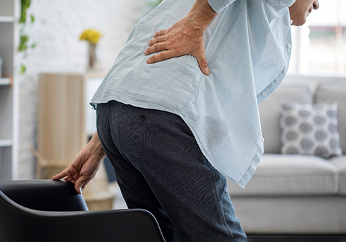 older man with lower back pain when standing up
