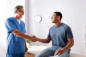 happy patient shaking hands with the chiropractor